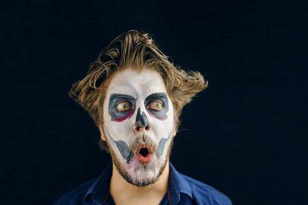 Masked man of the day of death on Halloween, surprised lookの写真素材