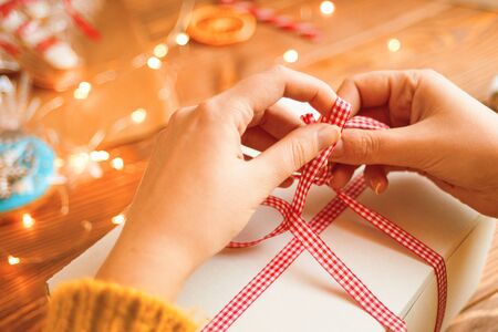 Christmas composition with present box. Festive gift box inside with red ribbon.の写真素材