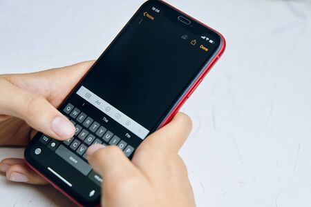 Bishkek, Kyrgyzstan - July 6 2019: New reminders application in ios 13. The person writes a reminder on the phone in a new application on iPhone X.のeditorial素材