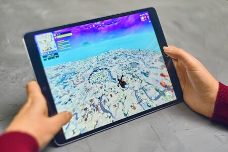 Bishkek, Kyrgyzstan - January 21, 2019: Woman playing fortnite game of epic games company on Apple ios tablet iPad Pro. Gameplay Actionのeditorial素材