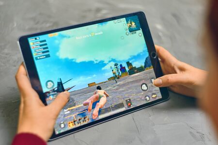 Bishkek, Kyrgyzstan - January 21, 2019: Woman playing pubg coop multiplayer battle royale game on Apple ios tablet iPad Proのeditorial素材