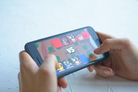 Bishkek, Kyrgyzstan - January 17, 2019: Playground battlefield. Man play a free mobile game brawl stars developed and published by Supercell on ios iphone and android.のeditorial素材