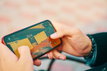 Bishkek, Kyrgyzstan - October 10, 2019: Man playing online game in call of duty mobile on iphone 11のeditorial素材