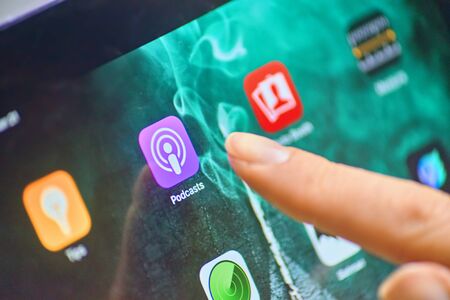 Bishkek, Kyrgyzstan - January 21, 2019: Close up to Apple Podcasts app on the screen of an Ipad Pro with personalized background and female finger touch on the appのeditorial素材