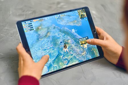 Bishkek, Kyrgyzstan - January 21, 2019: Woman playing pubg coop multiplayer battle royale game on Apple ios tablet iPad Proのeditorial素材