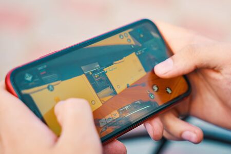 Bishkek, Kyrgyzstan - October 10, 2019: Man playing online game in call of duty mobile on iphone 11のeditorial素材