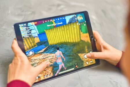 Bishkek, Kyrgyzstan - January 21, 2019: Woman playing pubg coop multiplayer battle royale game on Apple ios tablet iPad Proのeditorial素材