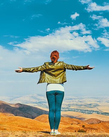 Beauty woman outdoors enjoying nature. Pretty young woman in field at sunsetの写真素材