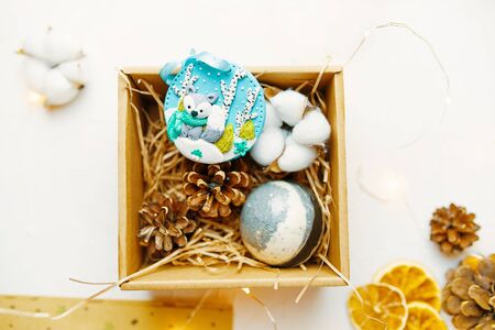 Christmas time. Process of packing gifts for holidays. Different things are in the gift box.の写真素材