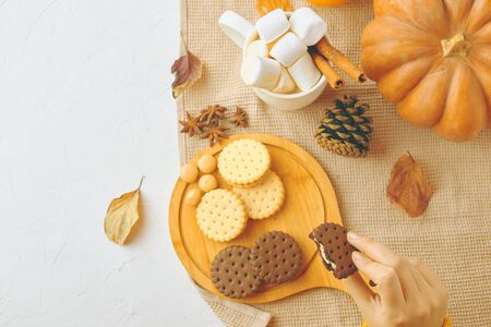 Woman eating cookies. girl drinking her coffee, eat cookies. Christmas timeの写真素材