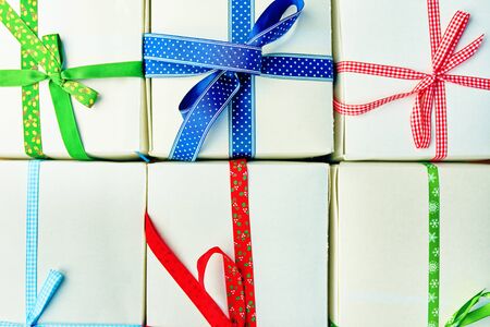 Stack of gift wrapped Christmas presents. Pile of boxes is stacked neatly on the table. View from above.の写真素材