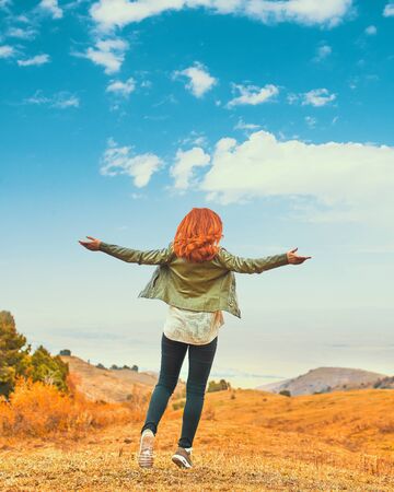 Beauty woman outdoors enjoying nature. Teenage girl enjoy with sunshine in field.の写真素材
