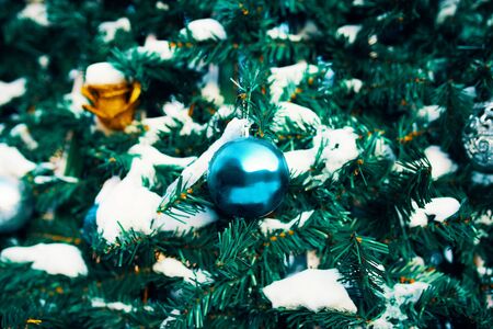 Decorated Christmas tree. Close-up of blue and gold balls hanging from a decorated Christmas tree.の写真素材