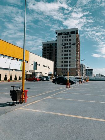 Shopping time. View of parking with cars near the business center and supermarket.の写真素材