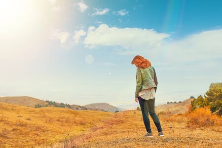 Beauty woman outdoors enjoying nature. Women enjoying nature in meadow. Fresh morning air summer Field at sunrise.の写真素材