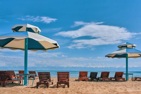 Sunbeds on the beach. Sun loungers with seats on the beach.の写真素材