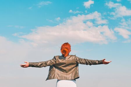 Beauty woman outdoors enjoying nature. Young happy female behind the blue skyの写真素材