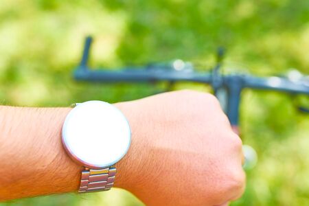 Man conducts Cycling training with a smart watch on the offroad at spring. Mockupの写真素材