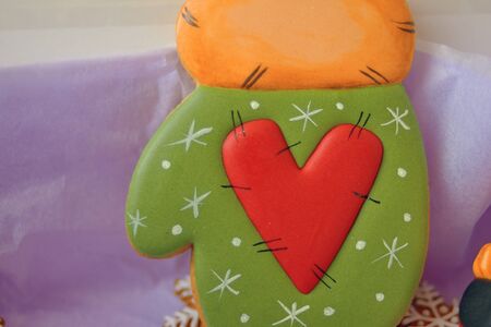 Valentines day gift. A green cookie shaped like a glove.の写真素材