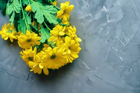 Yellow chrysanthemum flowers on the loft tableの写真素材