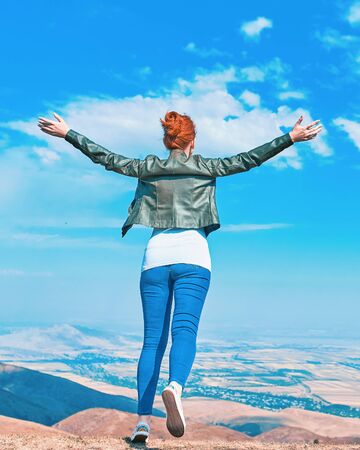 Beauty woman outdoors enjoying nature. Teenage girl enjoy with sunshine in field.の写真素材