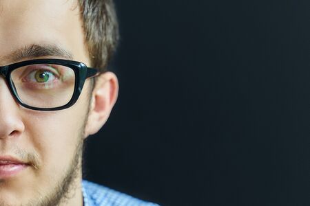 Man in glasses. Confident boy in eyeglasses looking at camera.の写真素材