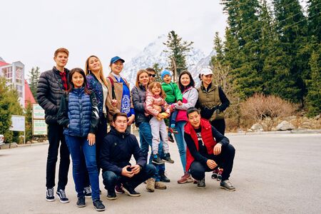 Bishkek, Kyrgyzstan - April 9, 2019: International mointain day. Tourists arrived at the hotel after a hike in the mountains. Group photo of hikersのeditorial素材