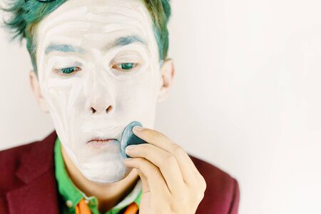 Man apply makeup. Man prepare for the performance.