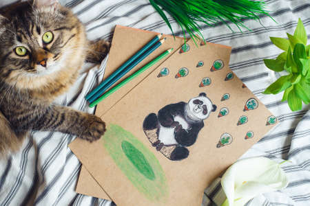 Bishkek, Kyrgyzstan - March 28, 2018: Painting concept. Paint of a Panda on a bed among flowers.のeditorial素材