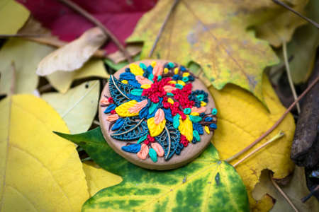 Bishkek, Kyrgyzstan - October 21, 2017: Painting concept. A homemade badge from clay.のeditorial素材