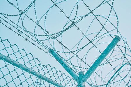 Border fence with barbed wire. Closing for quarantine. Maximum Security Detention Facility.の写真素材