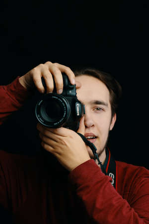Bishkek, Kyrgyzstan - December 15, 2019: Person takes pictures. Canon camera lens.のeditorial素材