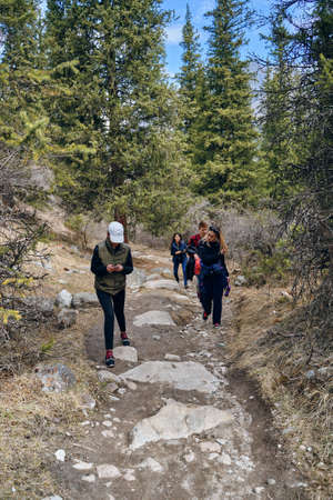 Bishkek, Kyrgyzstan - April 9, 2019: International mointain day. Hikers on the mountain trail as a concept of crowds going on trips in the summer.のeditorial素材