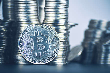 Large amount of bitcoin rise of cryptocurrency. Is it worth investing in crypto. Towers of coins. New virtual money concept. Silver coin with icon letter B. Mining or blockchain technology.の写真素材