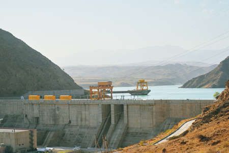 Dam in the mountains. View of a dike in the gorge. Hydropower station plant.の写真素材