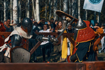 Festival of medieval culture. Imitation of jousting tournaments. Sword fighting. Arena with spectators. Bishkek, Kyrgyzstan - October 13, 2019のeditorial素材