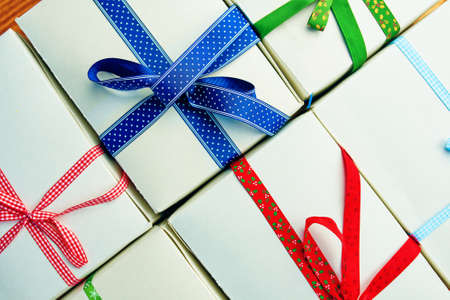 Festive pattern of gift boxes with ribbons. Composition for Christmas background. New Years or Birthday still life. Top view and flat lay.の写真素材