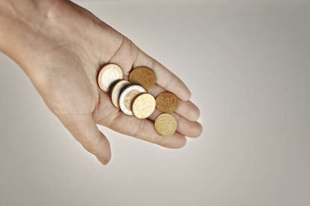 Top view of coins in womens hand. Concept of financial savings. Donations and alms. Close up.