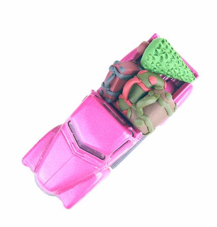 Flat lay of small purple pickup automobile. Car toy model with suitcases and christmas tree. Concept of festival travel and vacation. Miniature fir and briefcases made of polymer clay.の写真素材