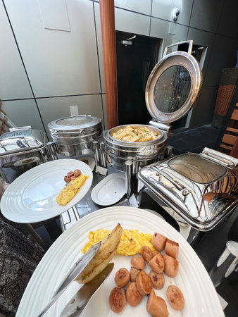 From a personal vantage point, someone is engaged in the act of plating food.の写真素材