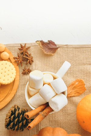 To create a warm and cozy autumn ambiance, decorate with fallthemed items and enjoy marshmallows for a festive touchの写真素材