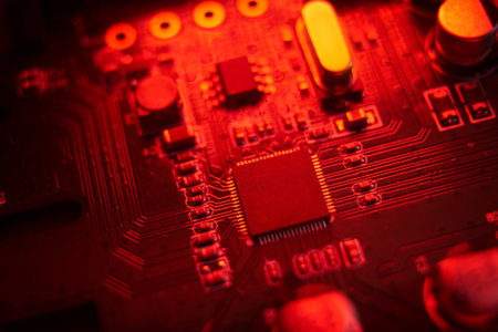 A visually striking macro shot featuring a detailed circuit board illuminated with vibrant red hues...