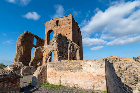 Beautiful architectural perspective of the Imperial Villa of the Quintilii, the caldarium, of the thermal baths, on a beautiful day of blue sky the ruins stand out against the blue. Rome Appian Way.の写真素材