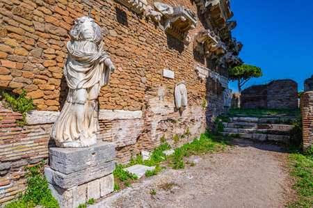 Rome Ostia Antica, Italy Ancient Roman ruins, architectural wall with marble Roman statue decorated architectural elements, archaeological park, Imperial era.のeditorial素材