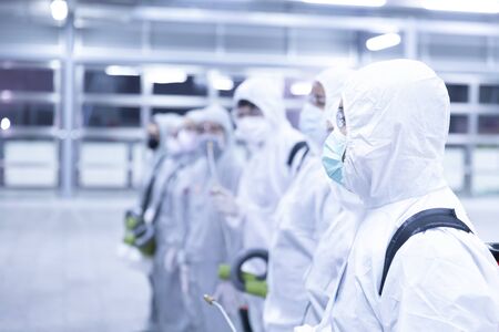 human in sterile suits disinfectant spray coronavirus big cleaningの写真素材