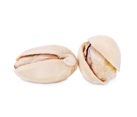 toasted pistachios on a white backgroundの写真素材