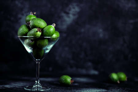 Feijoa. Fresh fruits of feijoa. Source of iodine. Set of ripe feijoa fruits on a dark background.