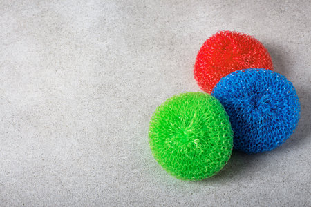 Colorful plastic scourers on a light neutral background. Gentle dishwashing. House cleaning.の写真素材