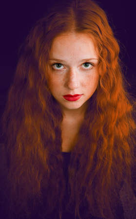 portrait of redheaded beautiful girl on white