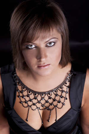 portrait of brunette girl in a black satin dressの写真素材